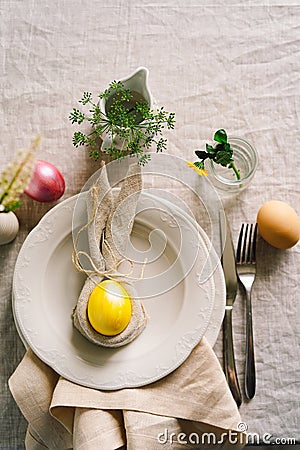 Happy Easter. Stylish easter eggs on a napkin with spring flowers on white wooden background Stock Photo