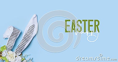 Happy Easter text with decorative easter banny ears and flowers. Easter greeting card or banner Stock Photo