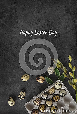 Happy Easter vertical greeting card.Small eggs in a cardboard box on a dark stone background with green leaves and willow branches Stock Photo