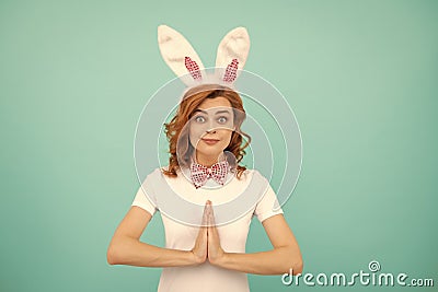 happy easter woman with rabbit ears on blue background. praying Stock Photo