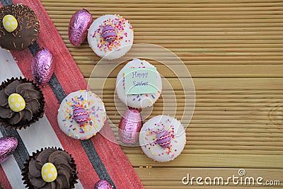 Happy Easter words with homemade cakes and Easter egg decorations Stock Photo