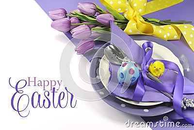 Happy Easter yellow and purple mauve lilac theme easter table place setting Stock Photo