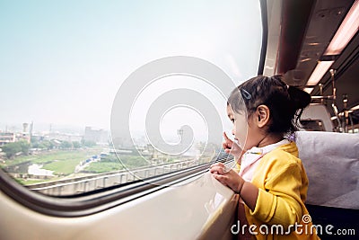 Happy and Ecxited Kids Traveling by Train. A Two Years old Girl Stock Photo