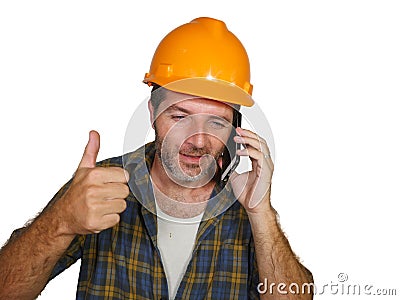 Happy efficient and cheerful workman or contractor man wearing builder hat tallking with satisfied customer on mobile phone Stock Photo