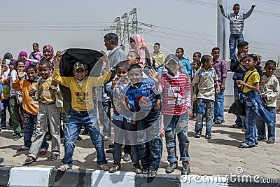 Happy Egyptian children pose for a photo outside the Russian monument near Aswan in Egypt. Editorial Stock Photo