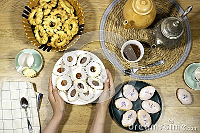 Happy Eid Al fitr Concept, hand hold an Oriental Algerian sweet cookies with apricot jam Stock Photo