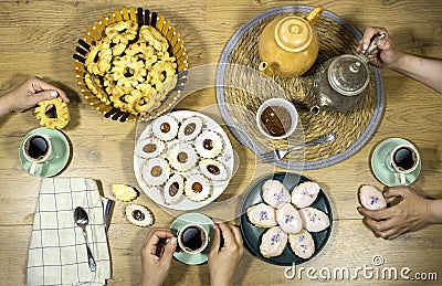 Happy Eid Al fitr Concept, women`s enjoying breakfast with friends. Top view of group of muslim people having coffee time together Stock Photo