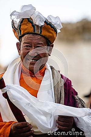 Happy Elder monk in traditional outfir at the Tibetan Buddhist Tiji Festival in Nepal Editorial Stock Photo