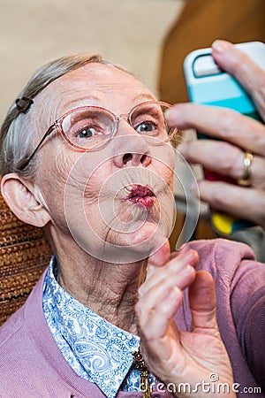 Happy Elder Woman taking Selfie Stock Photo