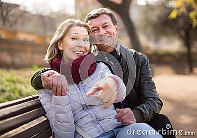 Happy elderly couple on a bench Stock Photo