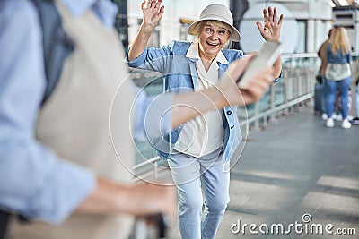 Pleased aged woman staring at a male with a smartphone Stock Photo
