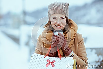 happy elegant woman in brown hat and scarf in camel coat Stock Photo