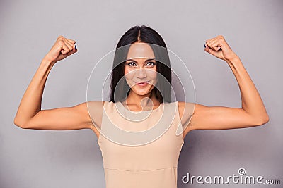 Happy elegant woman showing her biceps Stock Photo