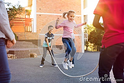 Children playing with skipping rope Stock Photo