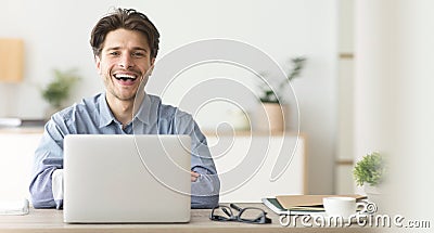 Happy Employee Smiling At Camera While Working On Laptop In Office Stock Photo