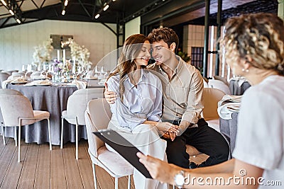 happy enamored couple sitting with closed Stock Photo