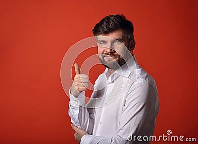 Happy enjoying bearded business showing the hand thumb up in wh Stock Photo