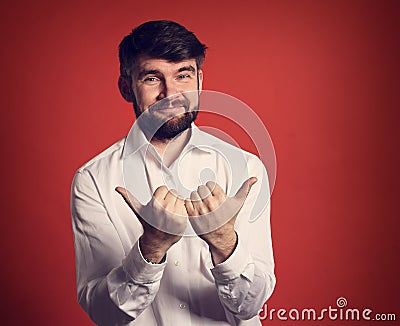 Happy enjoying bearded business showing two hands thumb up in w Stock Photo