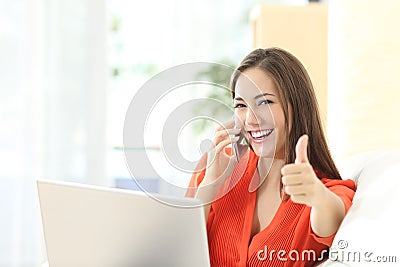 Happy entrepreneur working with thumbs up Stock Photo