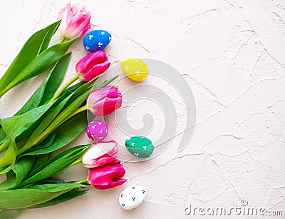 Happy ester. color eggs with tulips on background top view Stock Photo