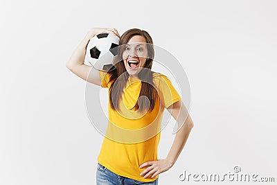 Happy European young woman, football fan or player in yellow uniform holding soccer ball support favorite team isolated Stock Photo