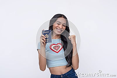 A happy and excited asian trans woman celebrating after receiving her American passport. Isolated on a white background Stock Photo
