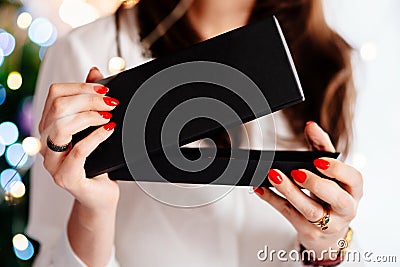 Happy excited beautiful young woman opening jewelry gift box. Stock Photo