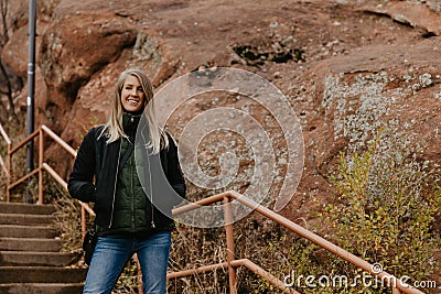 Young Beautiful Modern Caucasian Woman Smiling While Traveling to Red Rocks Park in United States Outside in Nature at Park Stock Photo