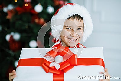 Happy excited child holding christmas gift box Stock Photo