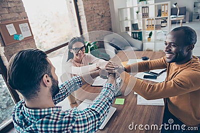 Happy excited delightful inspired smart clever intelligent authoritative business partners making building a towel with pile of t Stock Photo