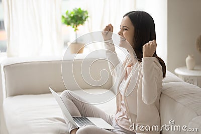 Happy excited millennial woman with laptop getting good news Stock Photo