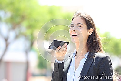 Happy executive dictating message on phone Stock Photo