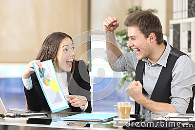 Happy executives celebrating good results with graph report Stock Photo