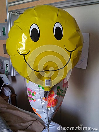 Happy faced get well balloon in hospital room Editorial Stock Photo