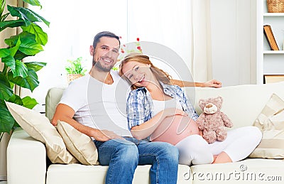 happy family in anticipation of the birth of baby. Pregnant woman and her husband at home Stock Photo