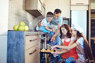 Happy family bakes buns in the oven in the kitchen Stock Photo