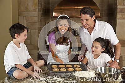 Happy Family Baking & Eating Cookies In A Kitchen Stock Photo