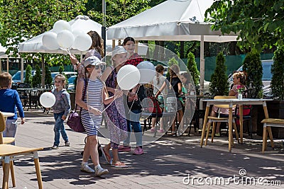 Happy family with baloons on the street during children protection day Editorial Stock Photo