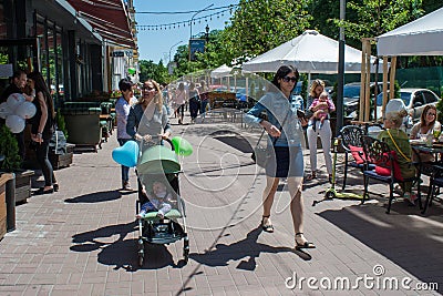 Happy family with baloons on the street during children protection day Editorial Stock Photo