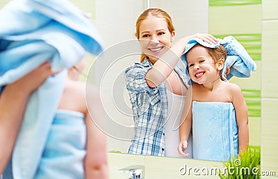 Happy family in bathroom. mother of a child with towel dry hair Stock Photo