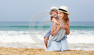 Happy family at beach. mother and child daughter hug at sea Stock Photo