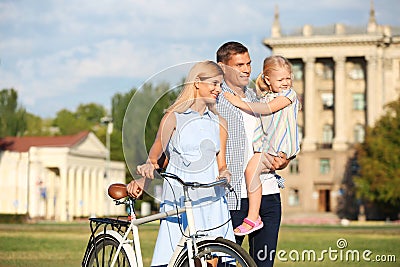 Happy family with bicycle outdoors Stock Photo