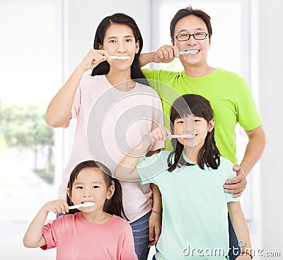 Happy family brushing their teeth Stock Photo