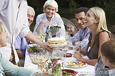 Happy Family Celebrating Birthday Outdoors Stock Photo