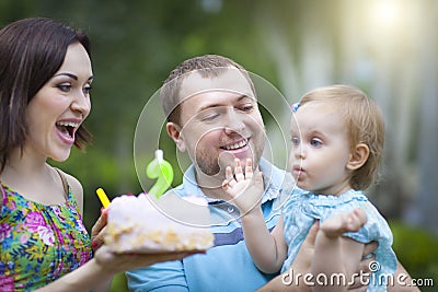 Happy family celebrating second birthday of baby daughter Stock Photo