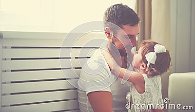 Happy family child baby girl in arms of his father at home Stock Photo