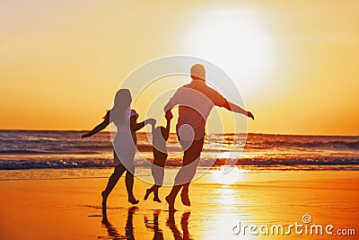 Happy family with child have a fun on sunset beach Stock Photo