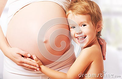 Happy family. Child hugs belly of pregnant mother Stock Photo