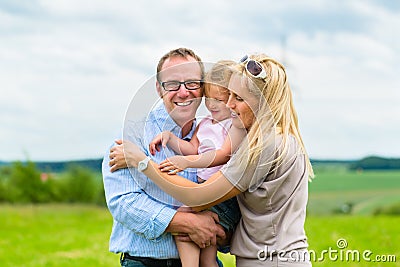 Happy Family with child in the meadow Stock Photo