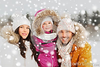 Happy family with child in winter clothes outdoors Stock Photo